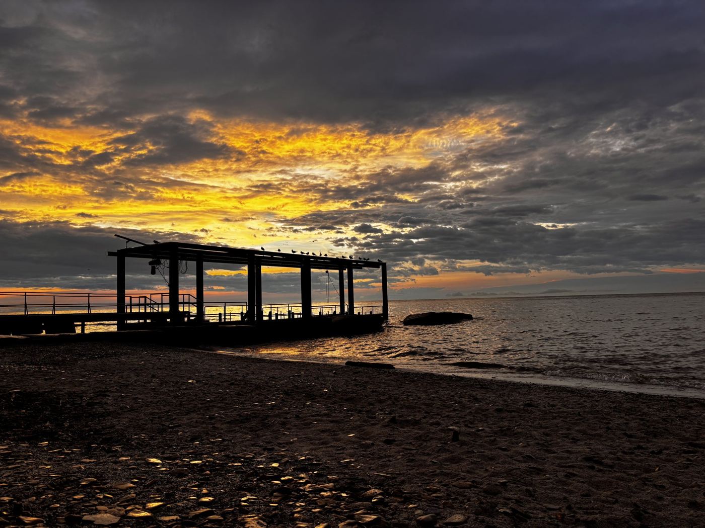 Wide sky over a pier at dusk